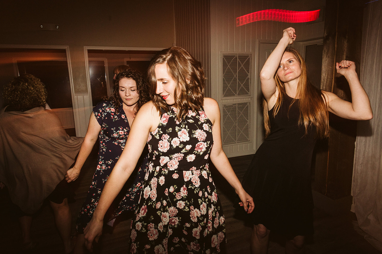 women in floral dresses dance at Lookout Mountain wedding