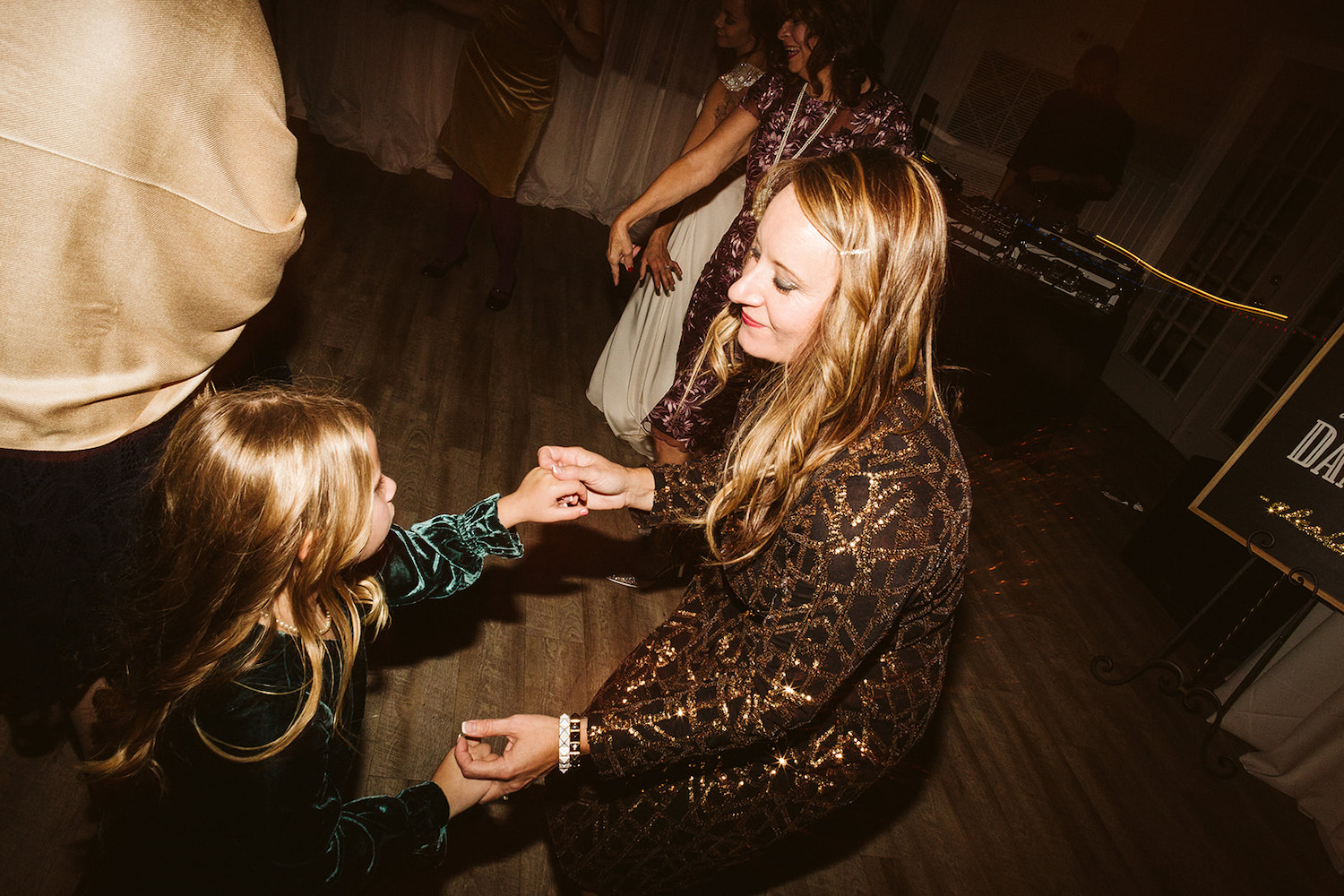 woman dances in the dark with a young girl