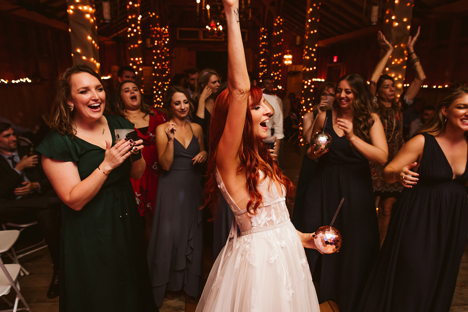 bride and friends cheer as the band plays at her Roan Mountain wedding reception