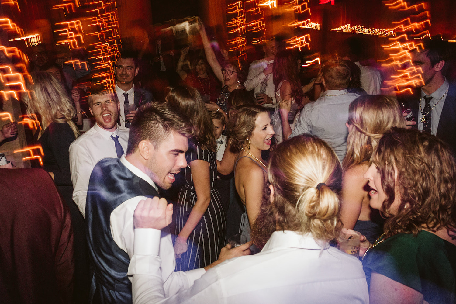 wedding guests dance and sing together