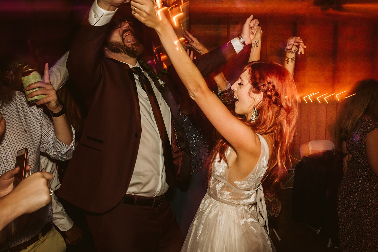 bride and groom dance and sing together among their guests at their Roan Mountain wedding reception