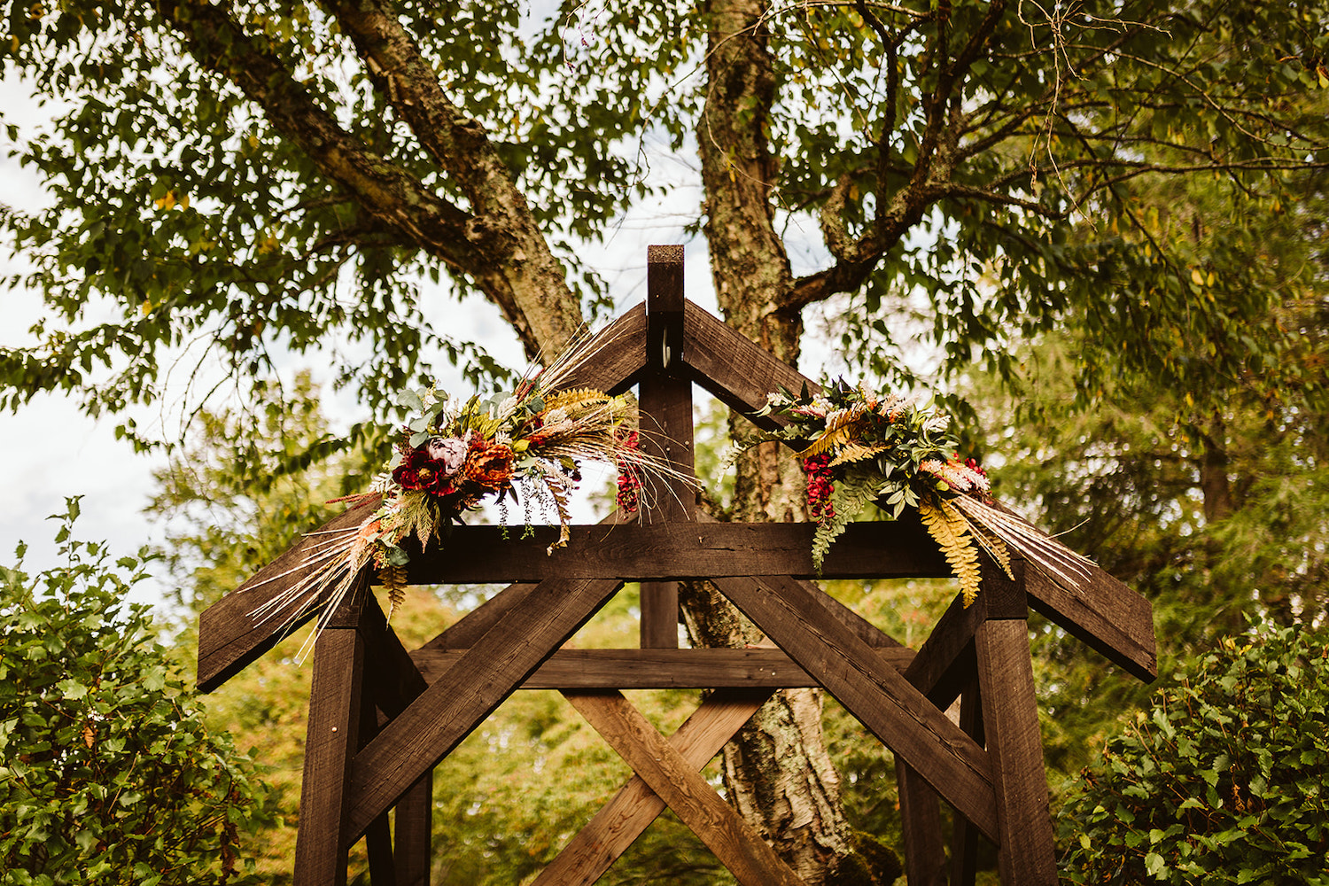 wooden archway decorated with bright florals