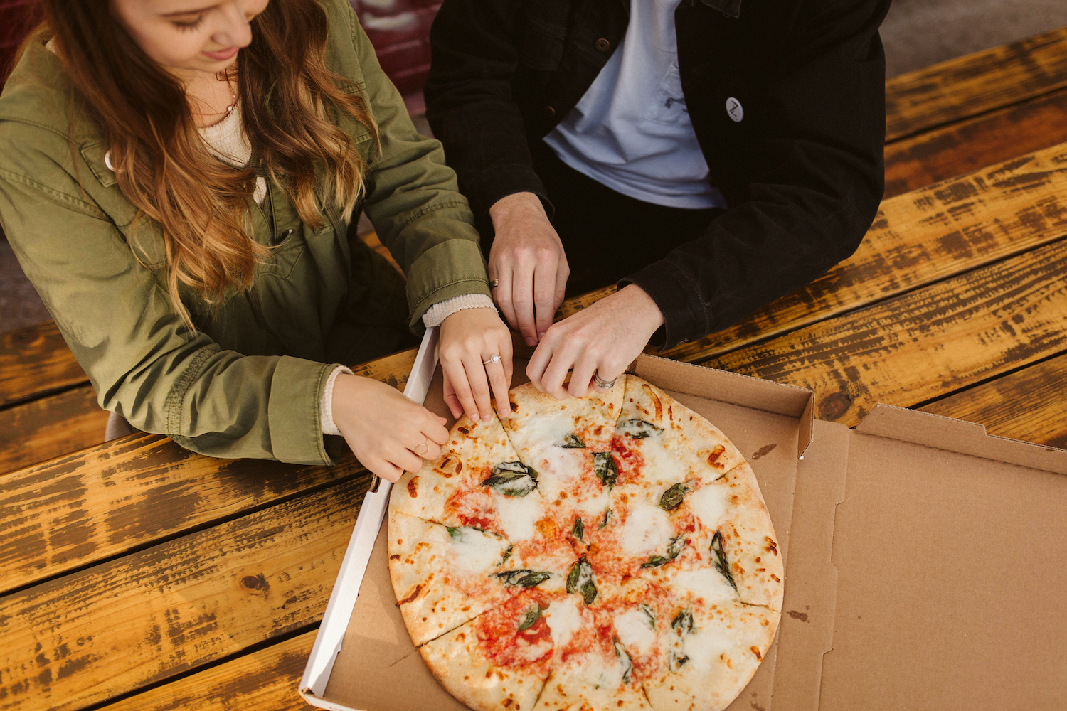 man and woman tear apart margarita pizza in downtown Chattanooga