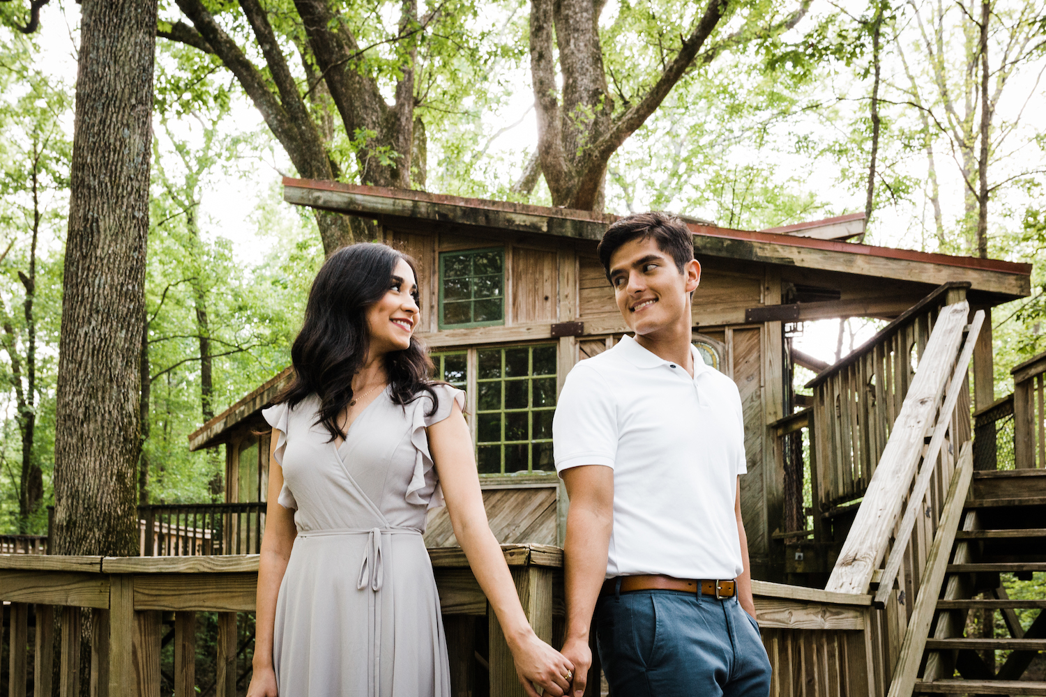 man and woman hold hands in front of treeehouse at Chattanooga's Reflection Riding Arboretum and Nature Center