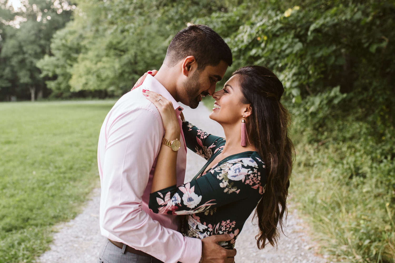 man in light pink button-down shirt hugs woman in green dress at Chattanooga's Reflection Riding Arboretum and Nature Center