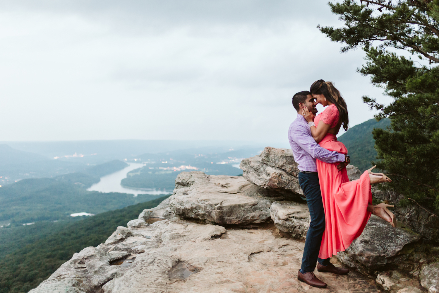 man carries woman on Sunset Rock on Lookout Mountain near Chattanooga and she leans her head down toward him