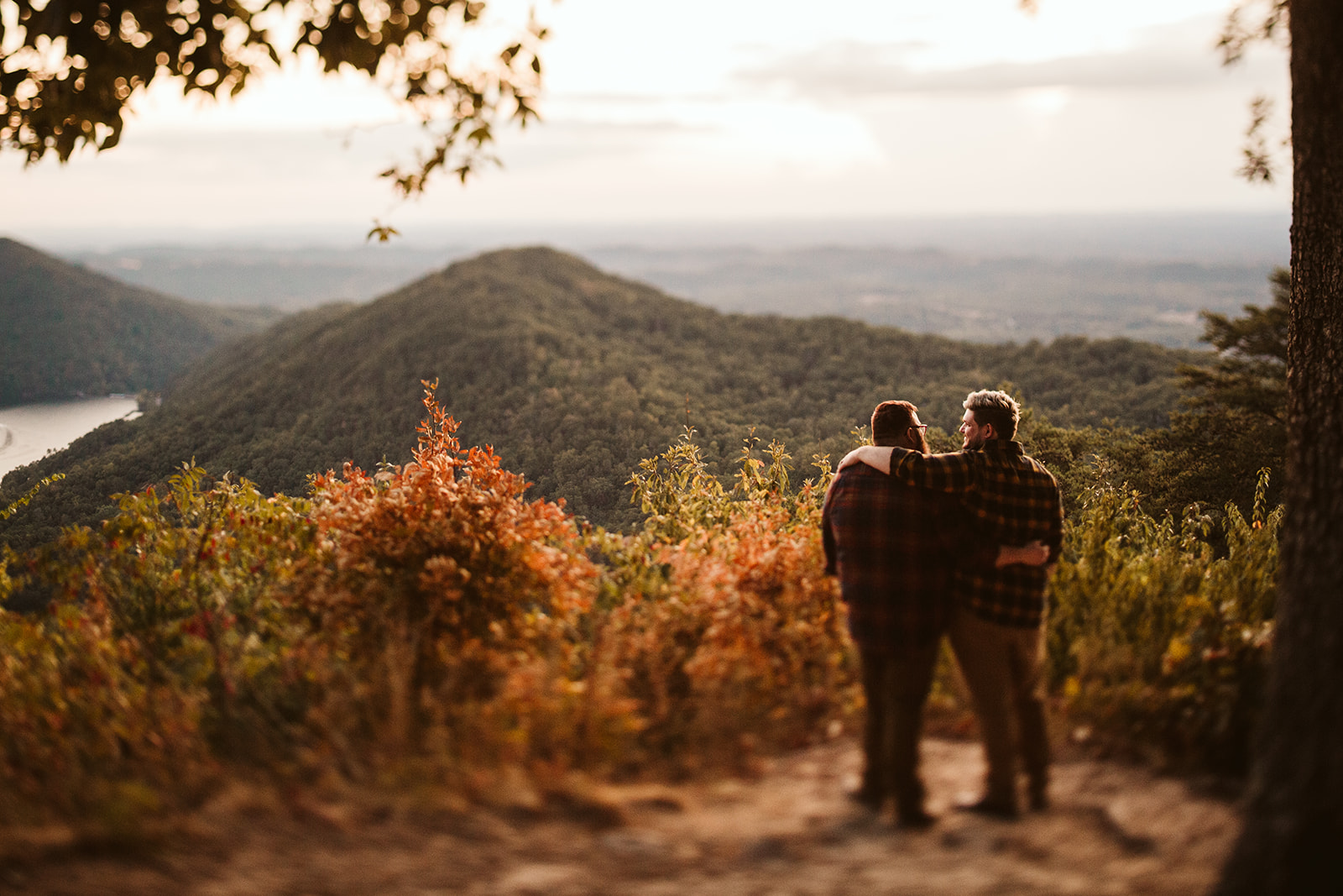 Couple embraces on a mountain overlook during their engagement photo session near Chattanooga.