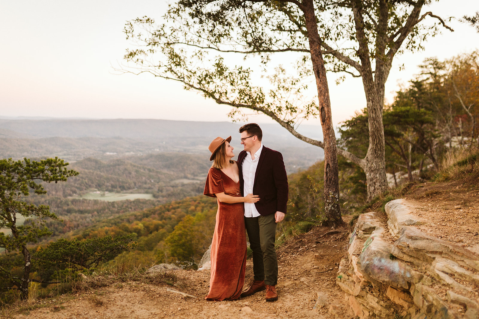 Couple embraces on a mountain overlook during their engagement photo session near Chattanooga.