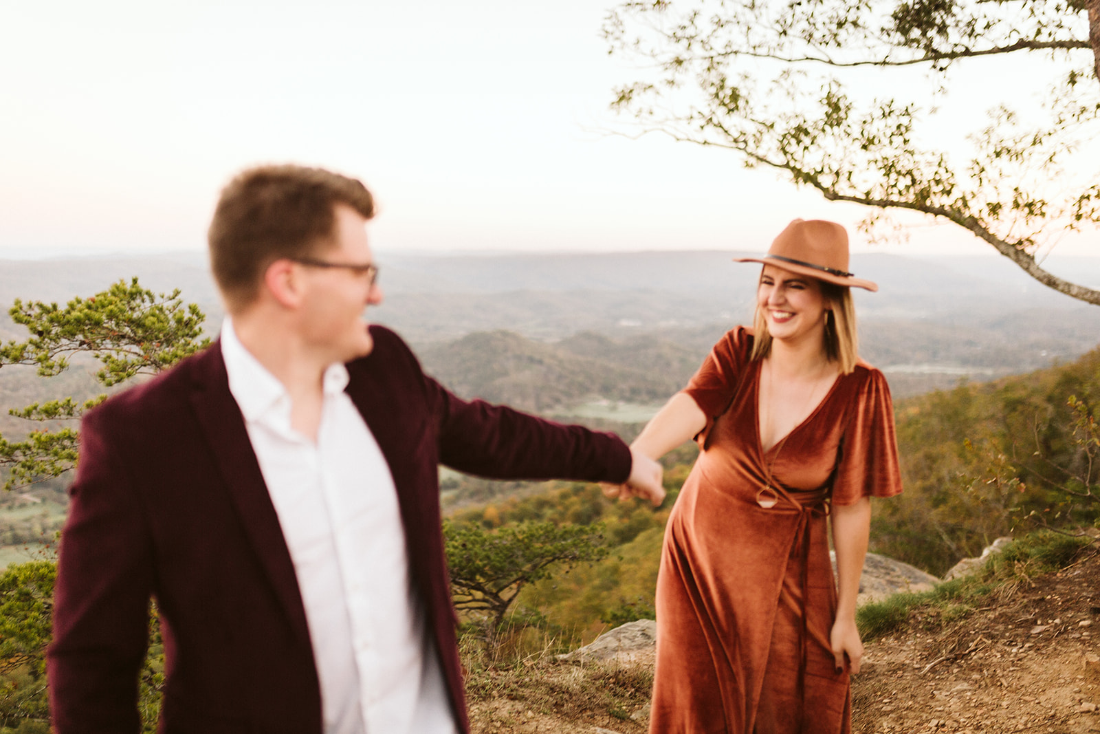 Couple dance on a mountain overlook during their engagement photo session near Chattanooga.