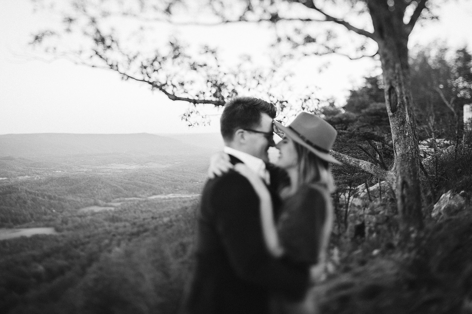 Couple kisses on a mountain overlook during their engagement photo session near Chattanooga.