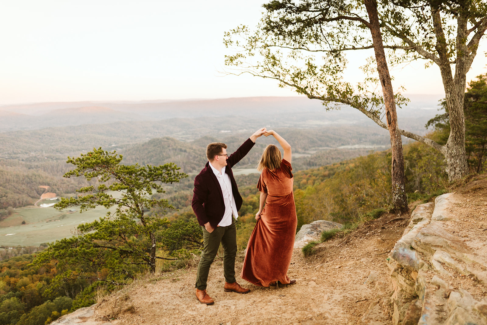 Couple dance on a mountain overlook during their engagement photo session near Chattanooga.