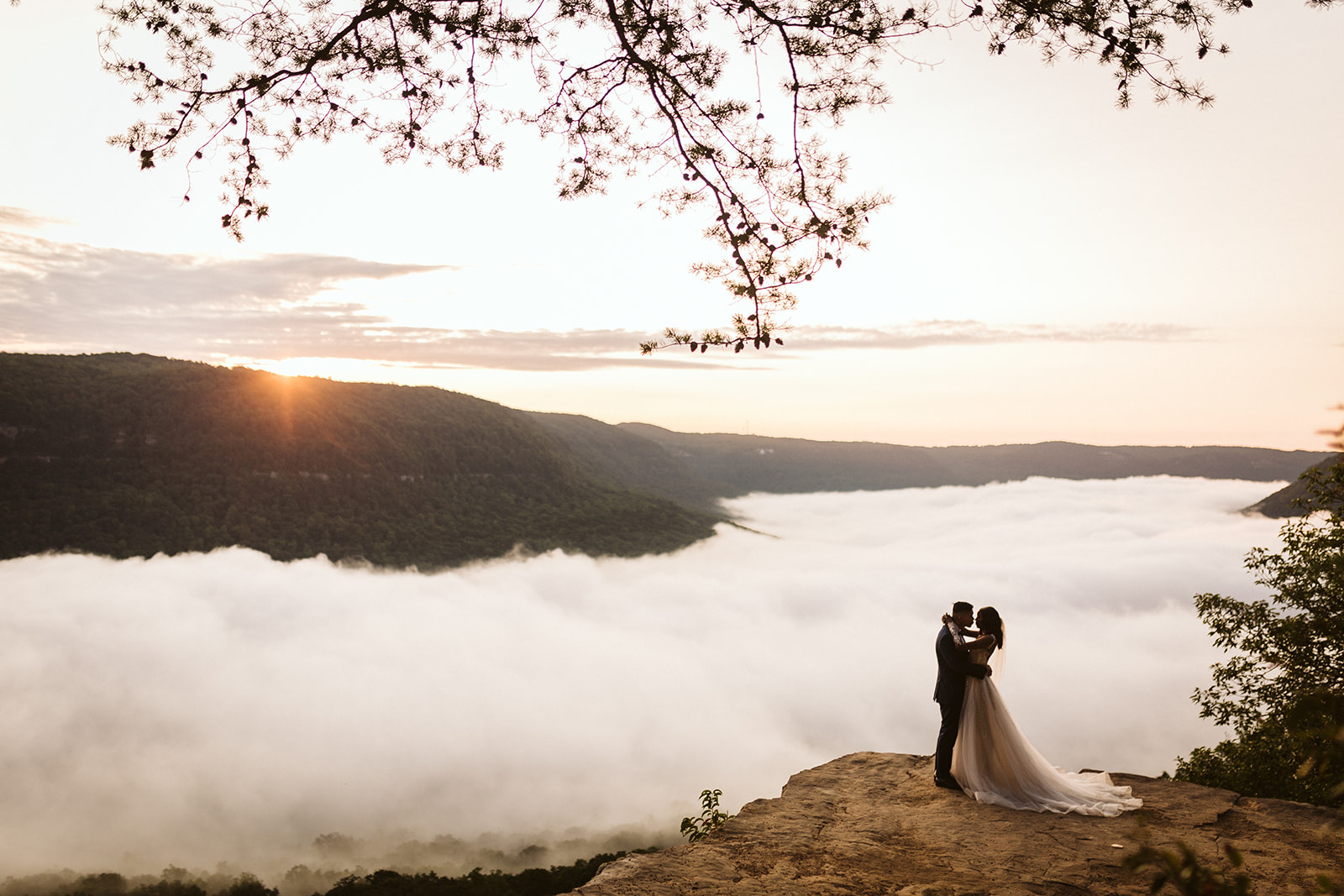 Couple kisses on a mountain overlook during their engagement photo session near Chattanooga.