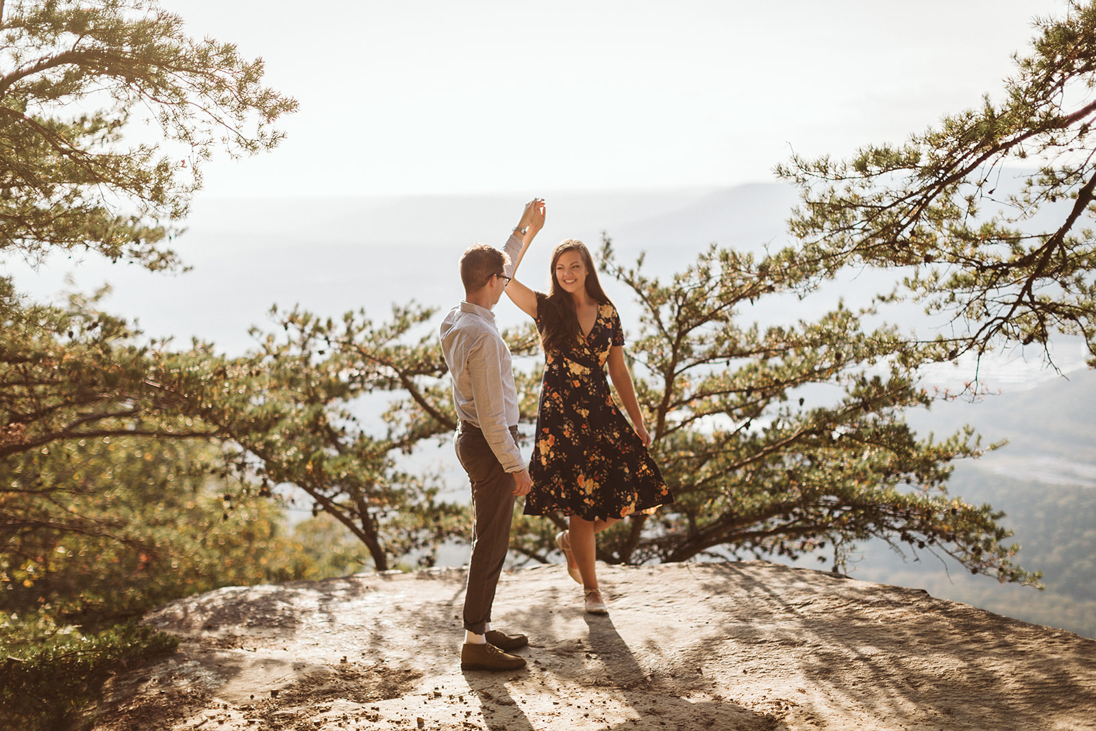 Couple dances on a mountain overlook during their engagement photo session near Chattanooga.
