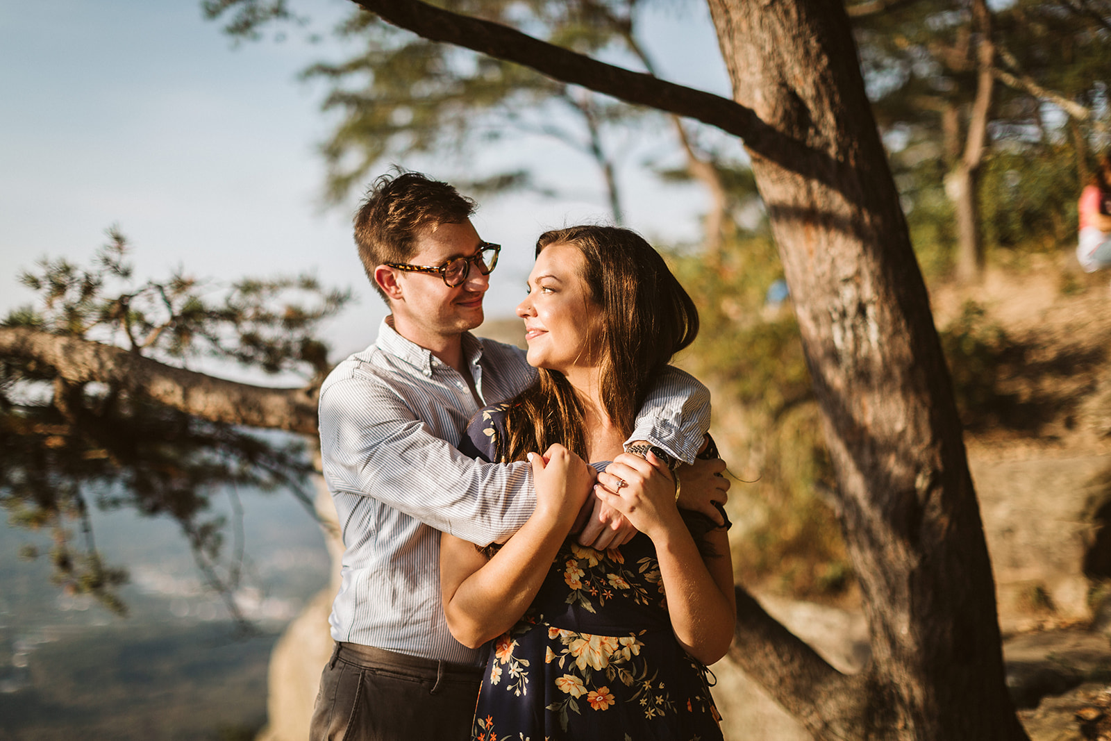 Couple embraces on a mountain overlook during their engagement photo session near Chattanooga.