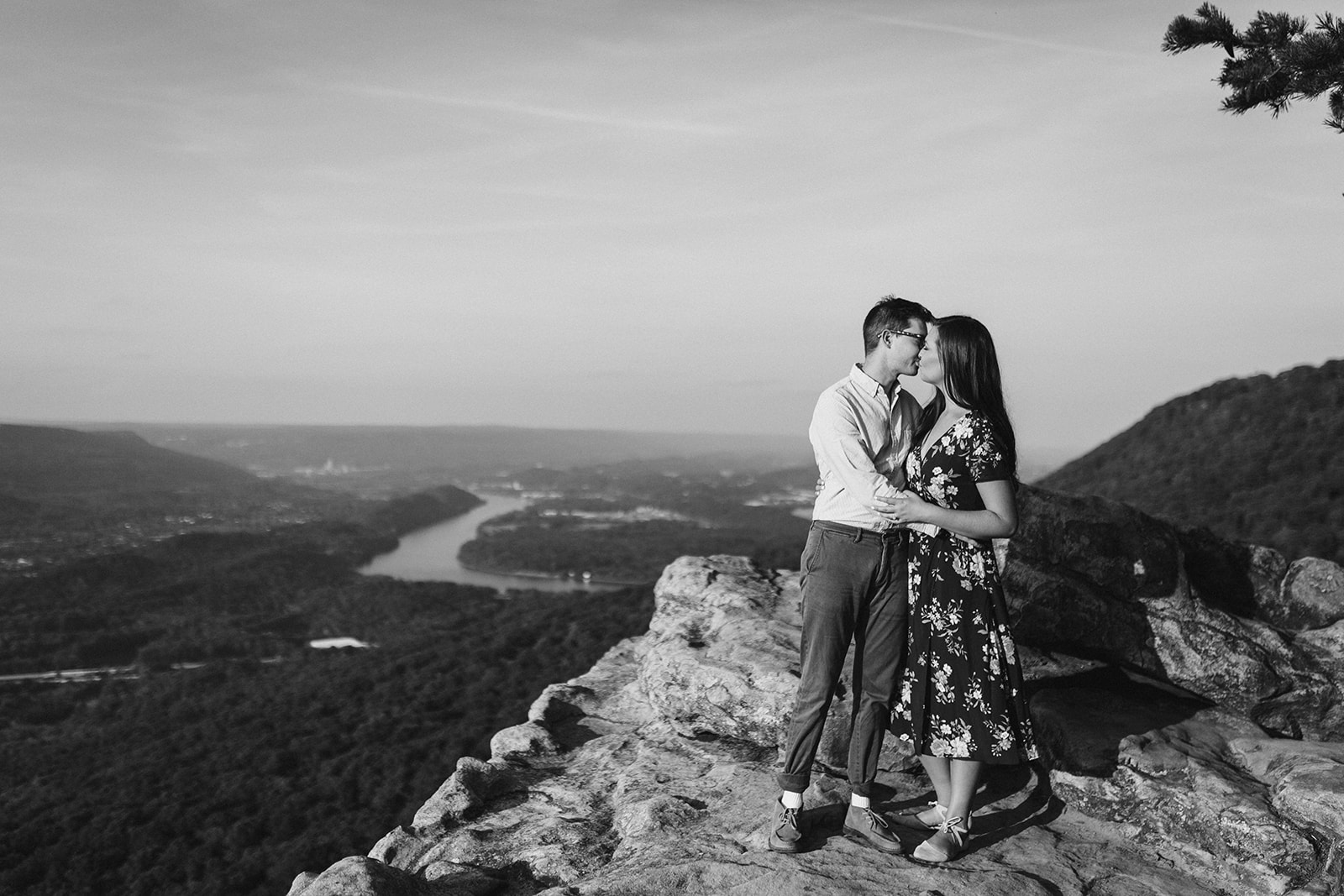 Couple embraces on a mountain overlook during their engagement photo session near Chattanooga.