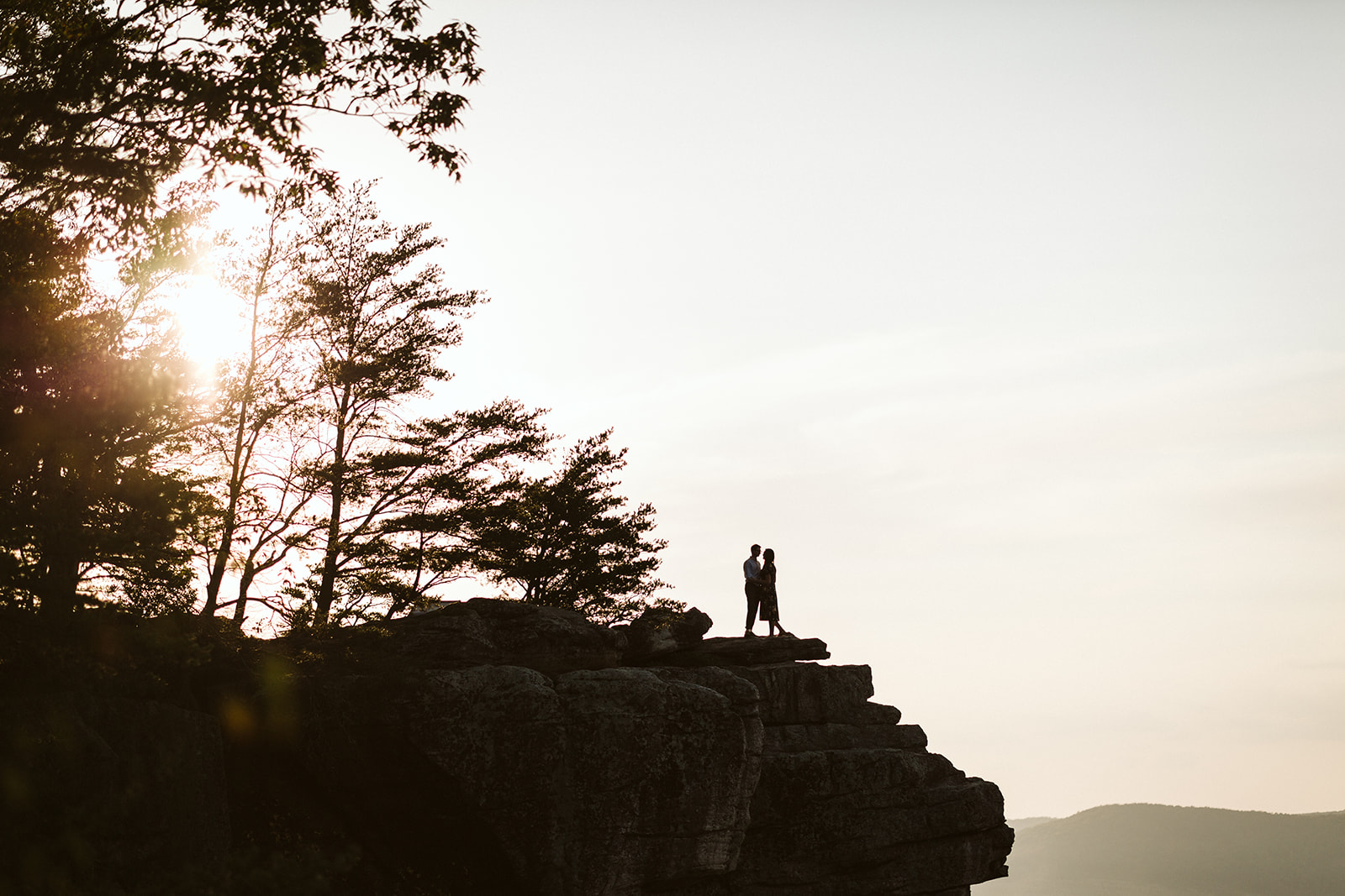 Couple embraces on a mountain overlook during their engagement photo session near Chattanooga.