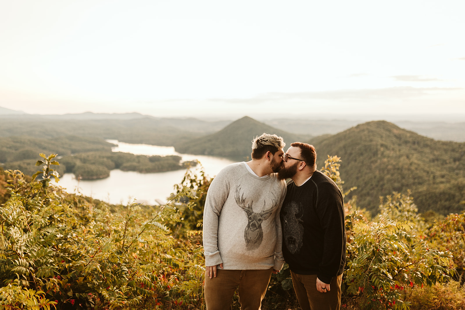 Couple kisses on a mountain overlook during their engagement photo session near Chattanooga.