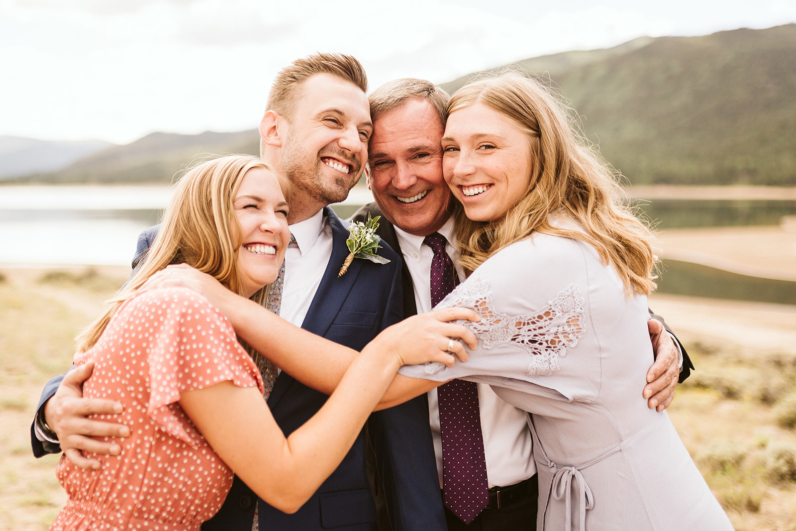 A family embraces for a wedding portrait.