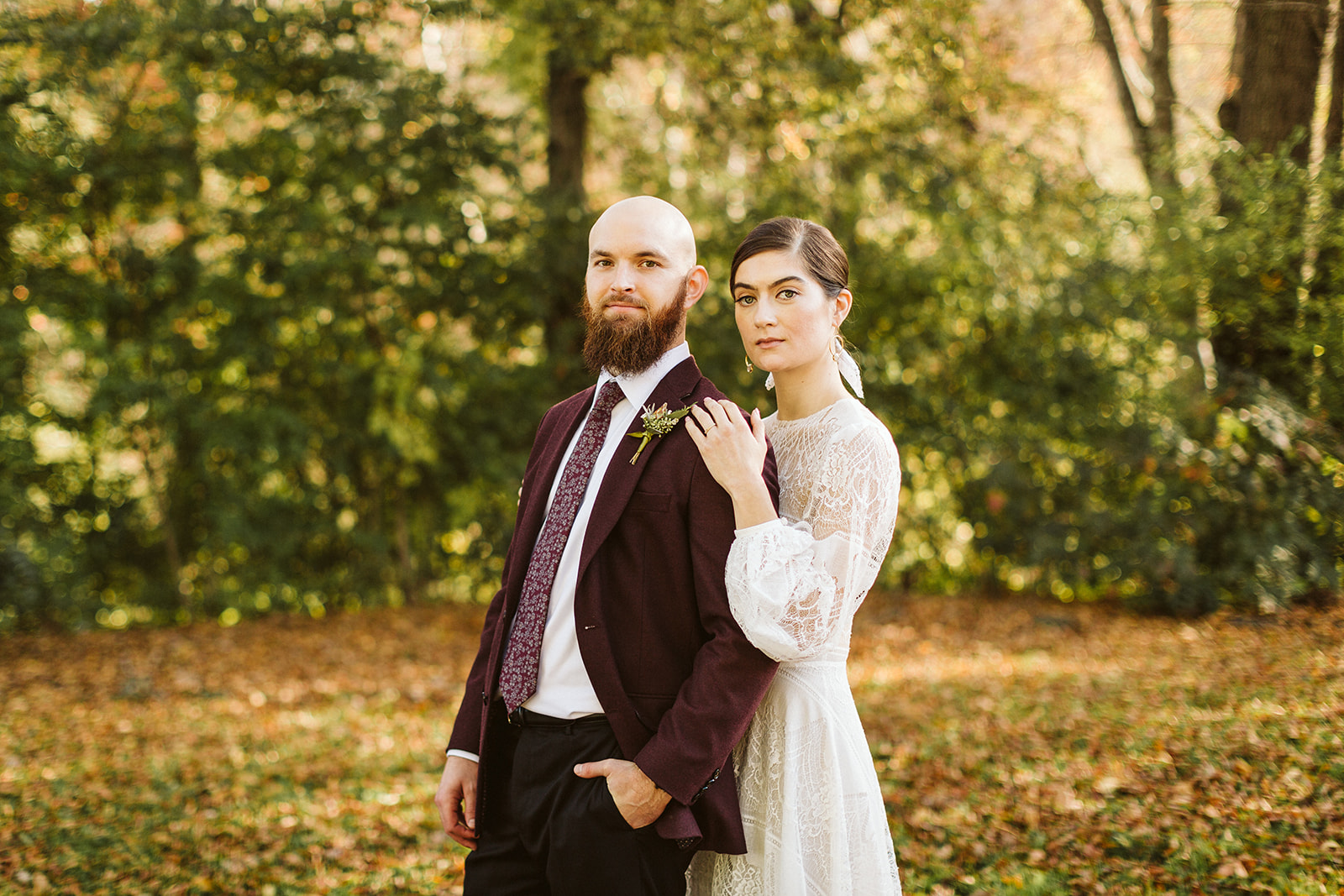 Bride stands behind groom as they look towards the camera outside the Tennessee Riverplace