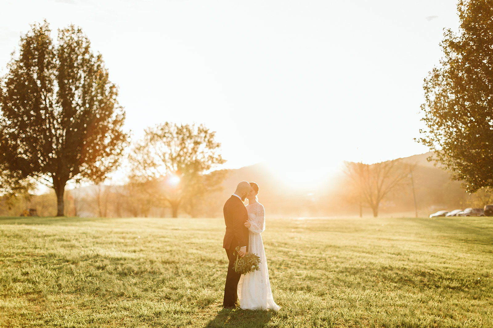 Bride and groom pull eachother close for a kiss outside their wedding at the Tennessee Riverplace