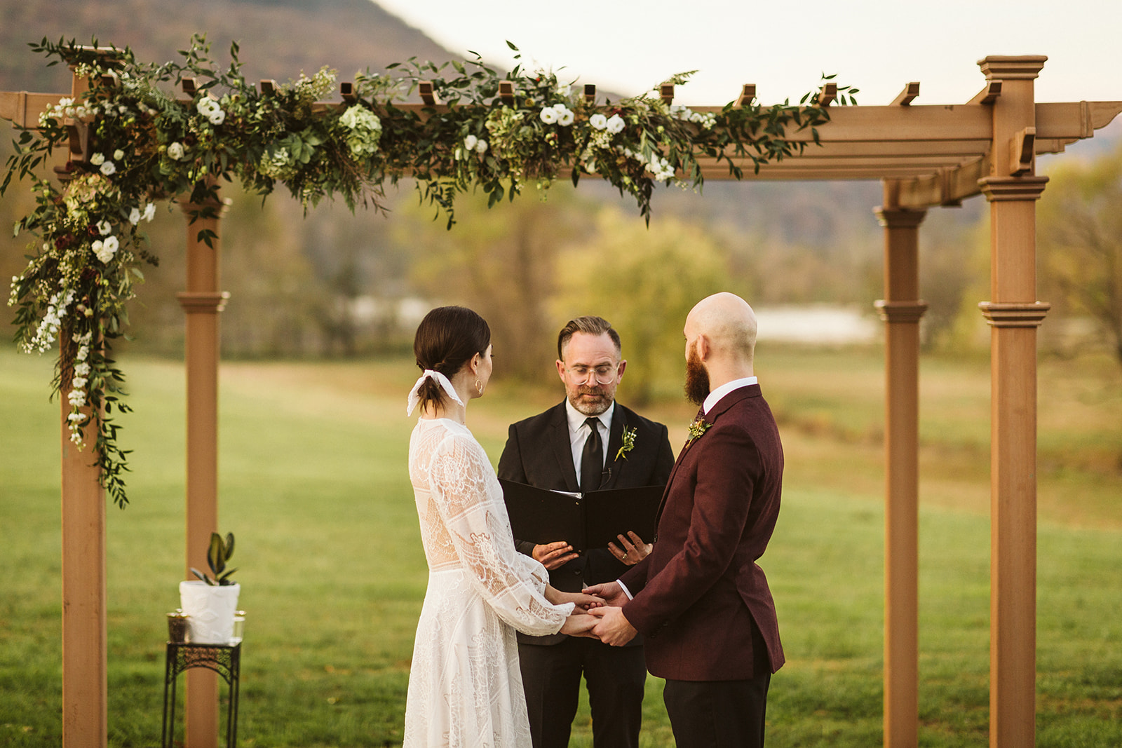 Bride and groom look at the officiant during their ceremony at the Tennessee Riverplace