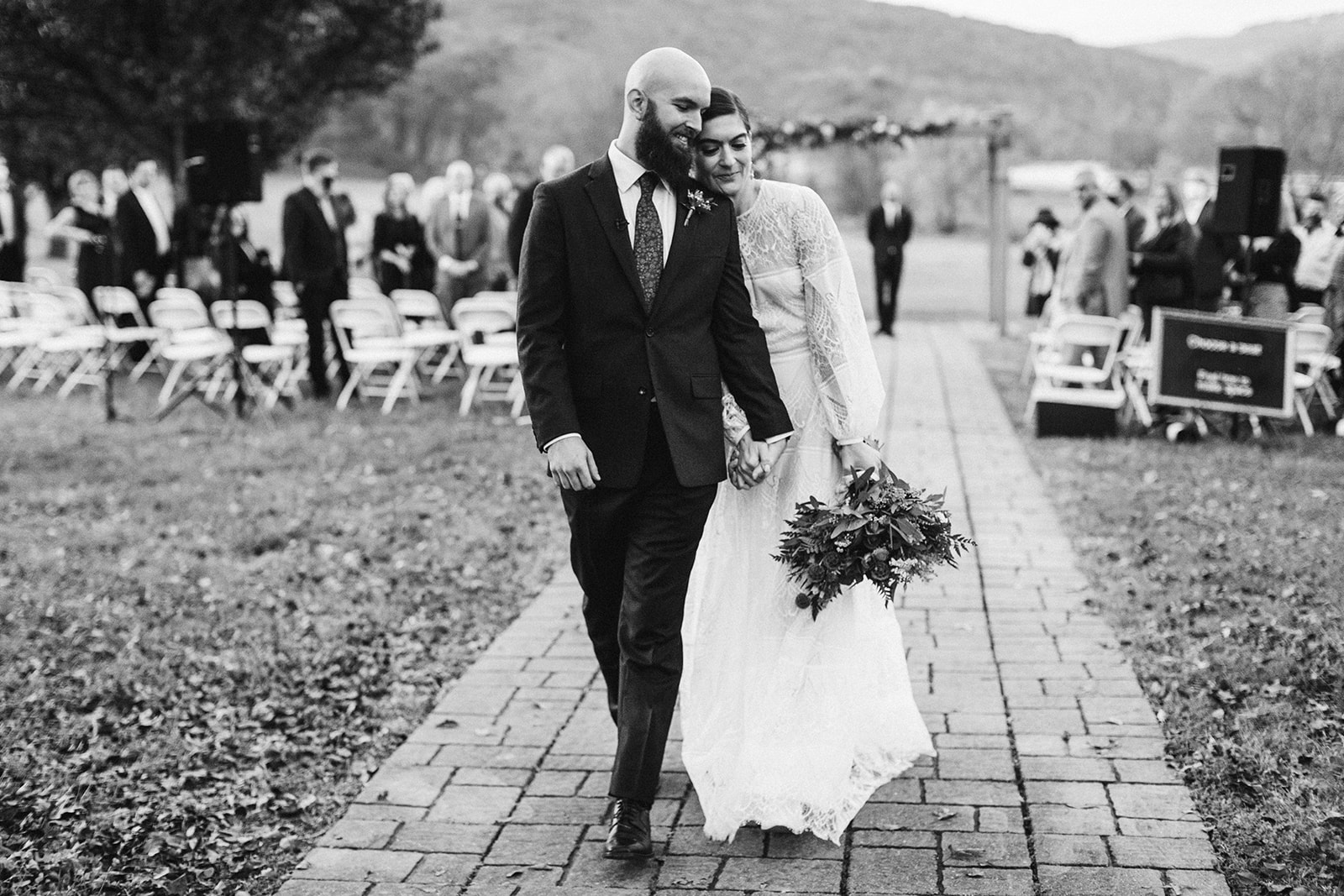 Bride leans against the groom as the walk inside after their wedding ceremony at the Tennessee Riverplace