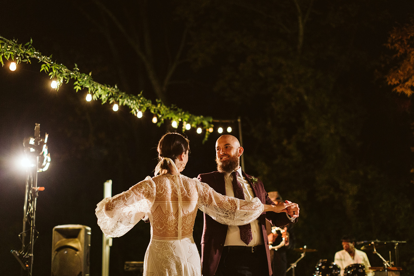 Bride and groom look at eachother and smile during their first dance at the Tennessee Riverplace