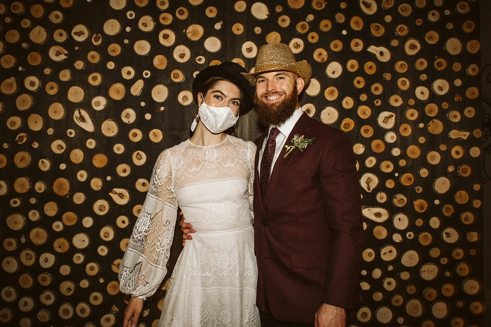 Bride and groom smile for a photo in silly hats during their wedding at the Tennessee Riverplace