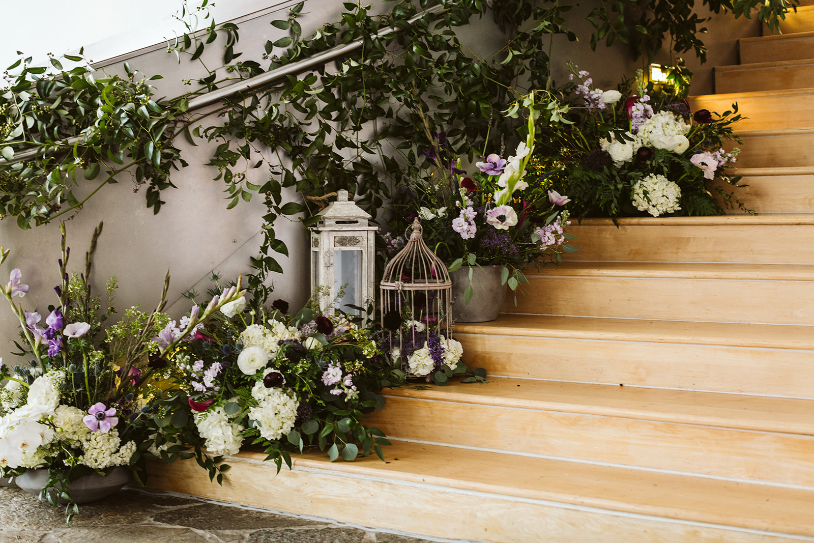 A floral arrangement trailing up a staircase at The Hunter Museum, a modern wedding venue in Chattanooga.
