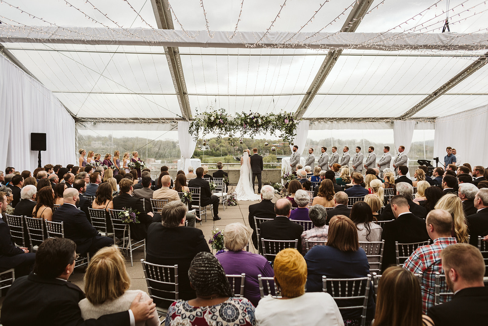 A wedding ceremony under a white canopy at The Hunter Museum.