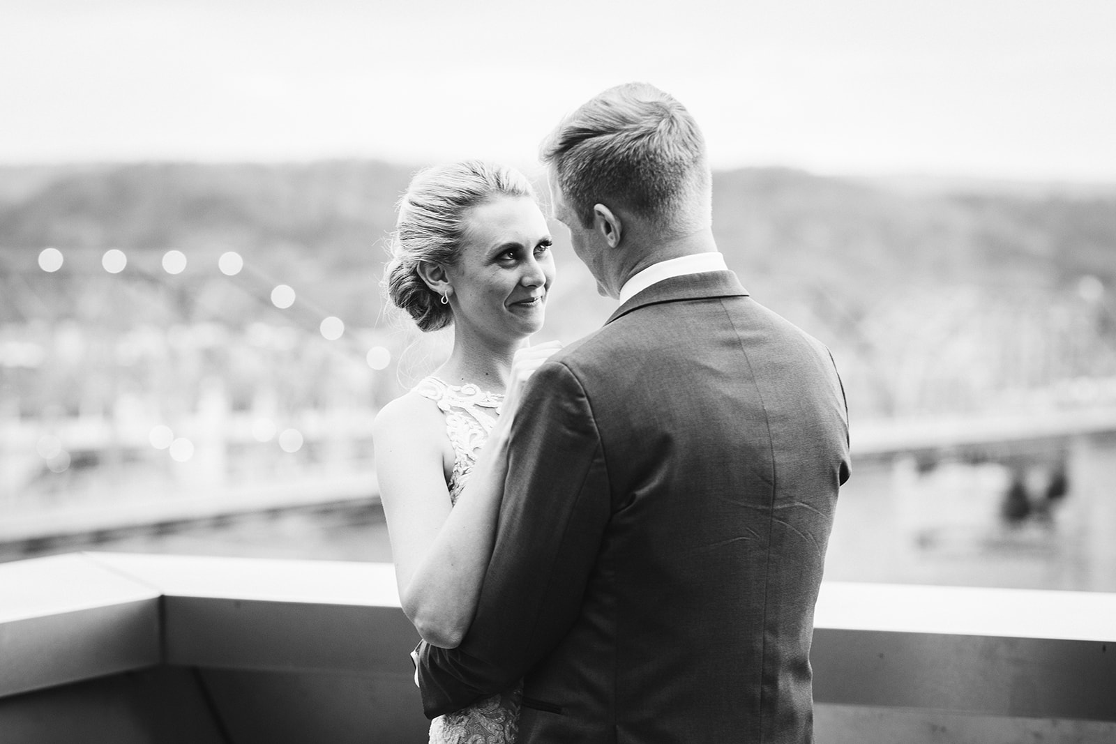 A bride and groom look into each other's eyes on a rooftop in Chattanooga.