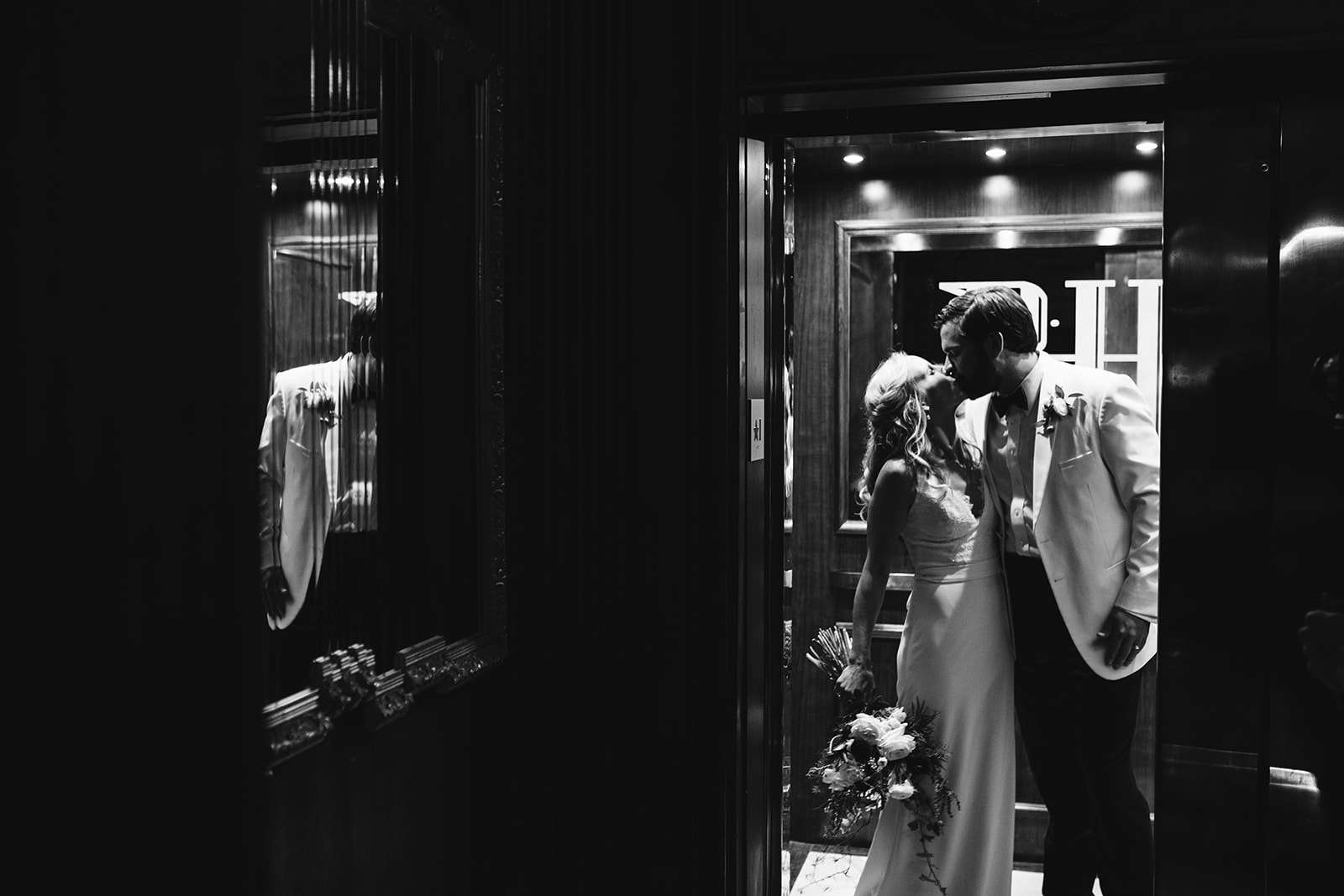 The bride and groom share a kiss the The Read House's elevator.