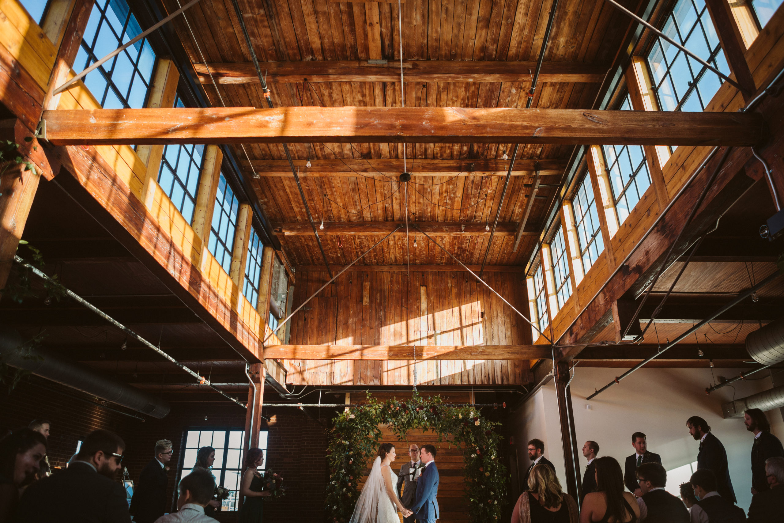 Bride and groom exchange vows beneath the vaulted ceiling of The Turnbull Building.