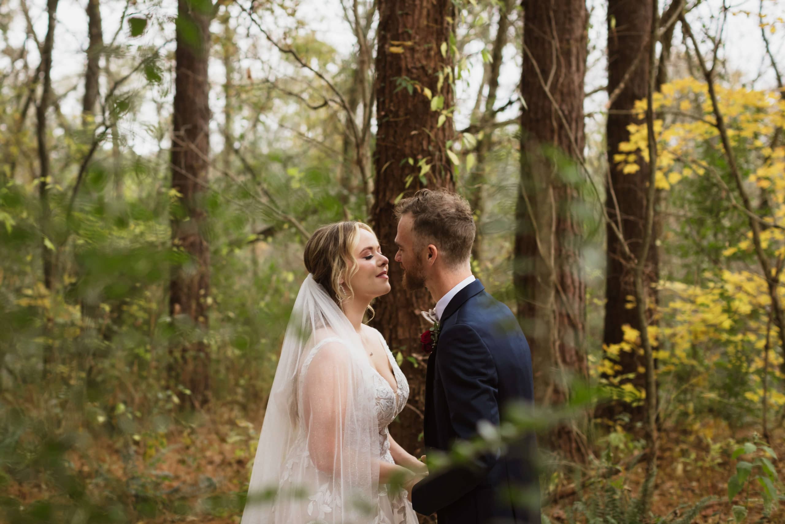 Forest first look session at Hiwassee River Weddings. Photo by OkCrowe Photography.