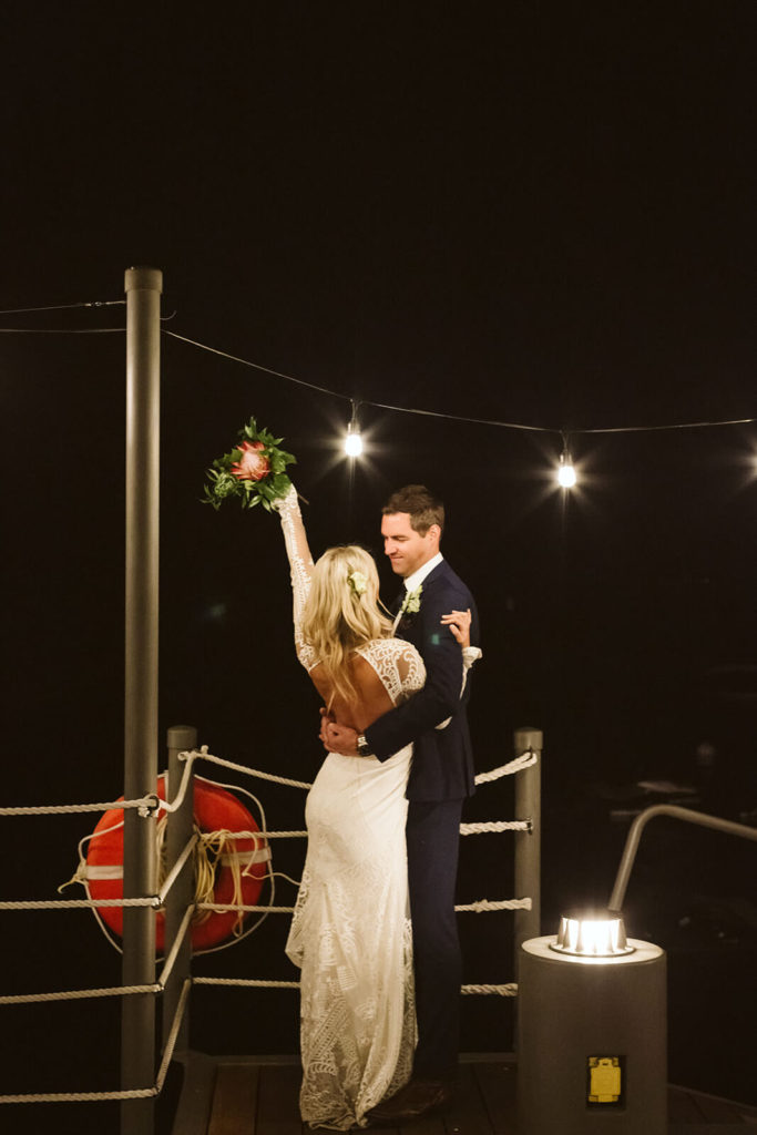 Nighttime bride and groom portraits on the pier of the Westshore Cafe and Inn. Photo by OkCrowe Photography.