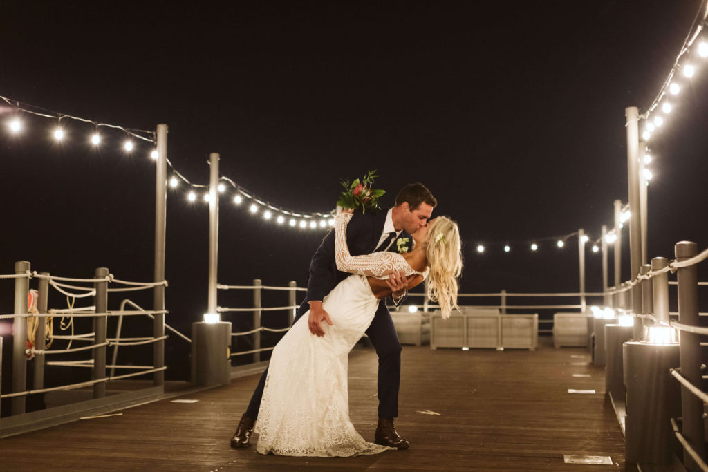Nighttime newlywed lakeside portrait at the West Shore Cafe and Inn. Photo by OkCrowe Photography.