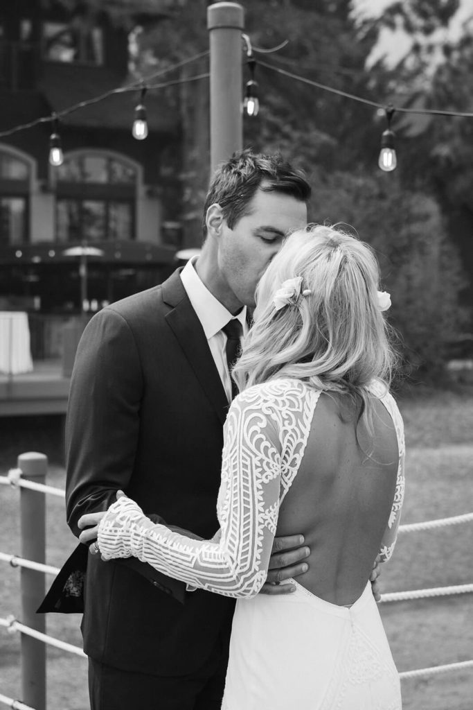 Bride and groom on the pier of the Westshore Cafe and Inn. Photo by OkCrowe Photography.