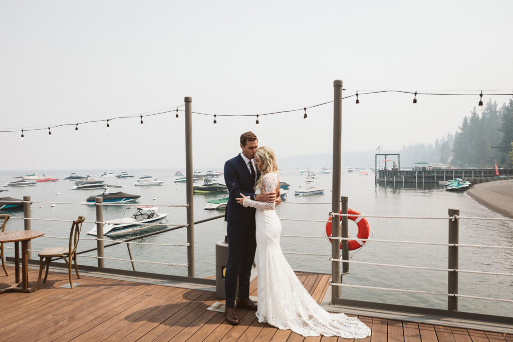 Bride and groom on the pier of the Westshore Cafe and Inn. Photo by OkCrowe Photography.