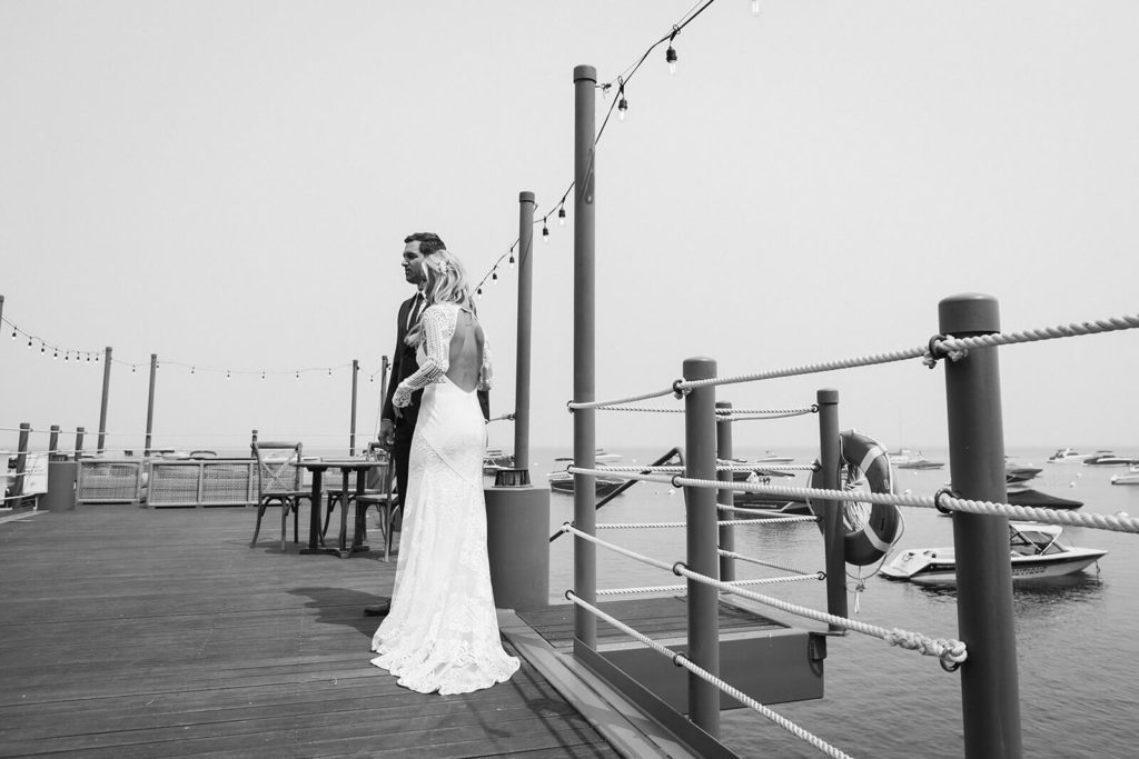 Bride and groom on the pier of the Westshore Cafe and Inn. Photo by OkCrowe Photography.