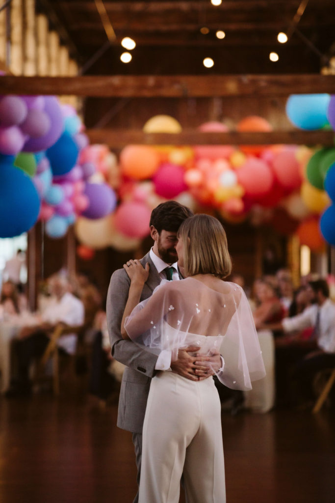 Modern industrial wedding ceremony at the Turnbull Building in Chattanooga with colorful balloon installation. Photo by OkCrowe Photography.