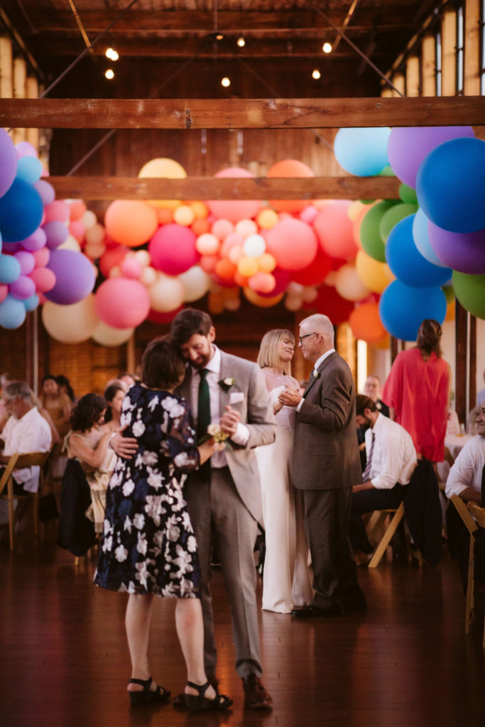 Modern industrial wedding ceremony at the Turnbull Building in Chattanooga with colorful balloon installation. Photo by OkCrowe Photography.