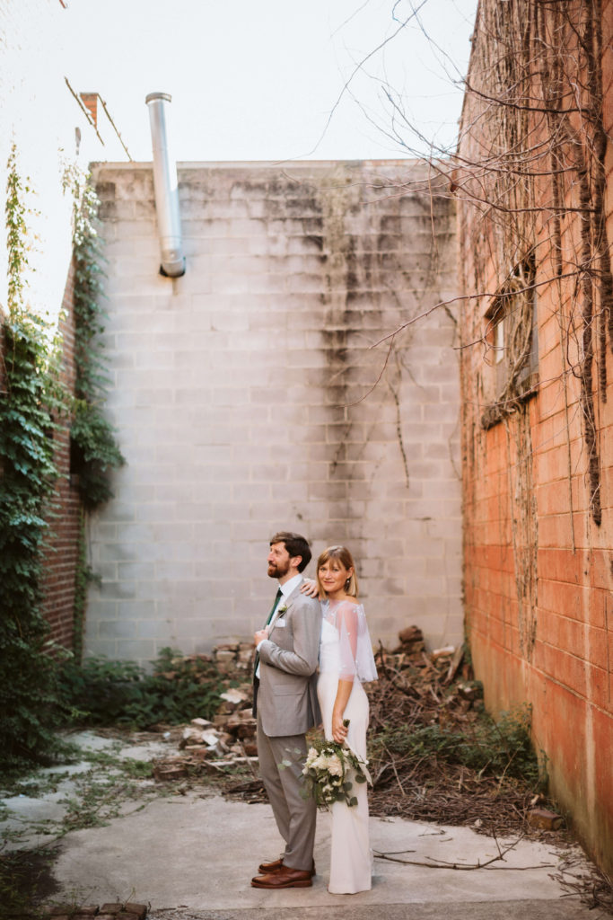 Newlywed portraits behind the Turnbull Building in Chattanooga. Photo by OkCrowe Photography.