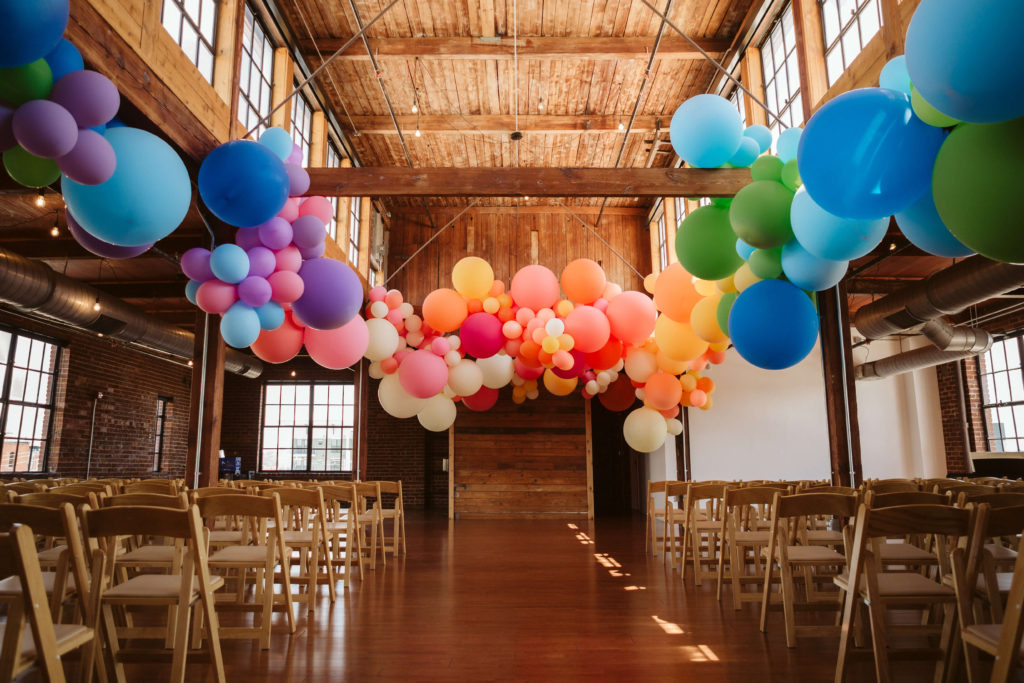 Colorful wedding decorations for a modern industrial wedding at the Turnbull Building in Chattanooga. Photo by OkCrowe Photography.