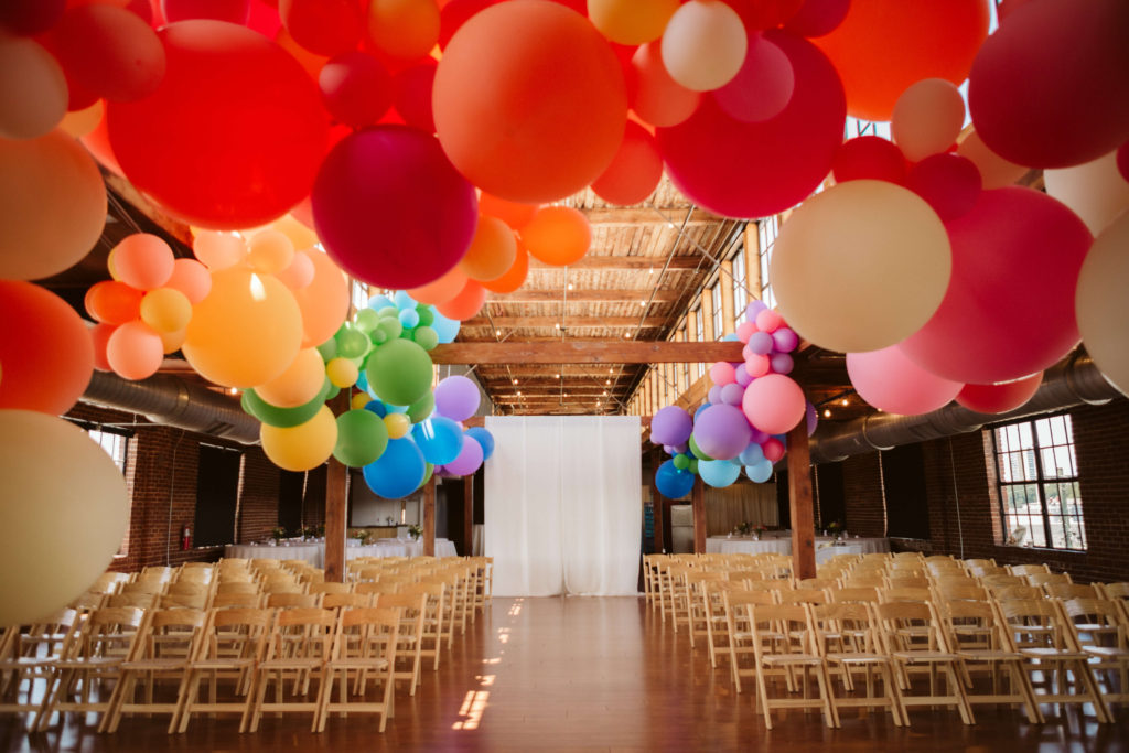 Colorful wedding decorations for a modern industrial wedding at the Turnbull Building in Chattanooga. Photo by OkCrowe Photography.