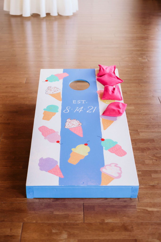 Custom cornhole board with a colorful wedding. Photo by OkCrowe Photography.