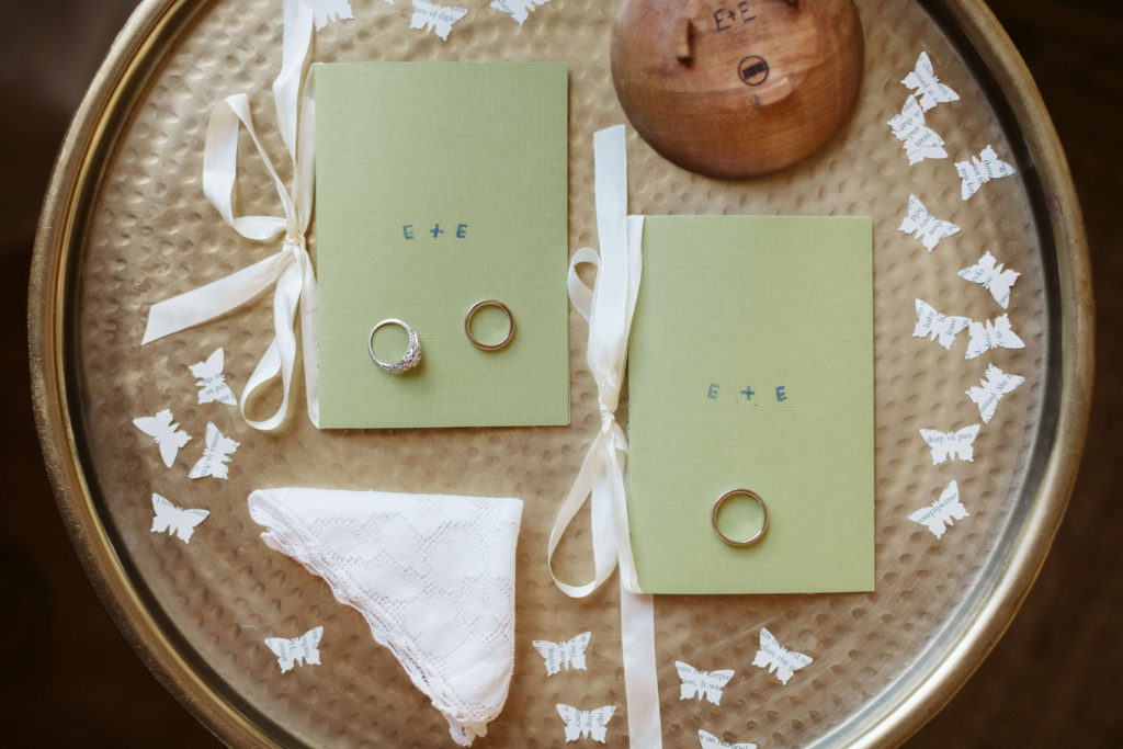 Mint green vow booklets and wedding rings for a modern wedding. Photo by OkCrowe Photography.