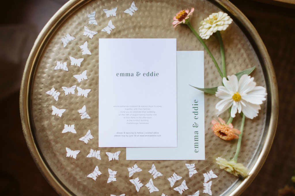 Minimalist wedding invitation with flowers and butterfly confetti. Photo by OkCrowe Photography.