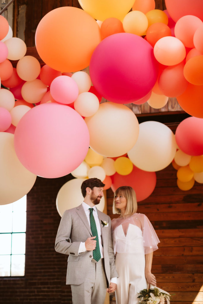 Modern industrial wedding ceremony at the Turnbull Building in Chattanooga with colorful balloon installation. Photo by OkCrowe Photography.