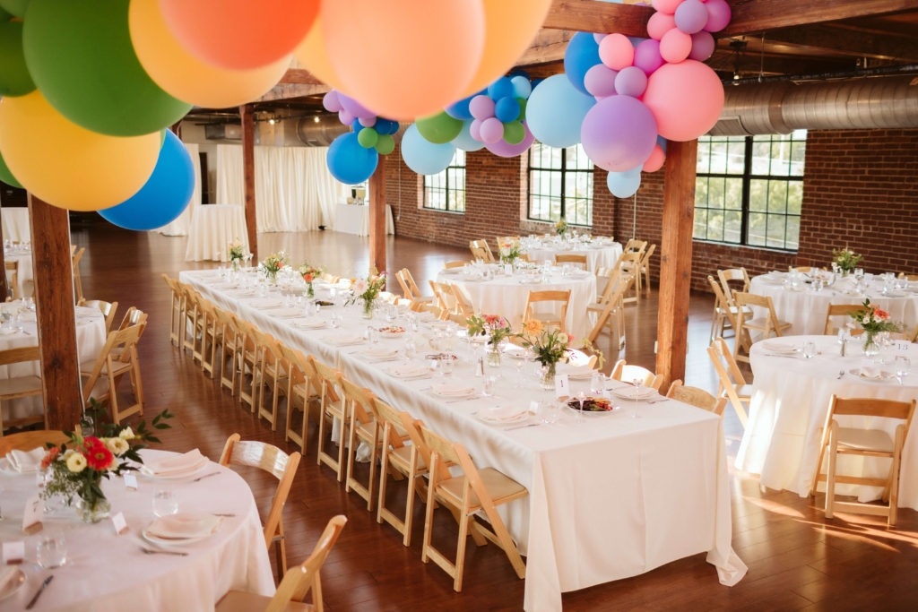 Modern industrial wedding reception at the Turnbull Building in Chattanooga with colorful balloon installation. Photo by OkCrowe Photography.