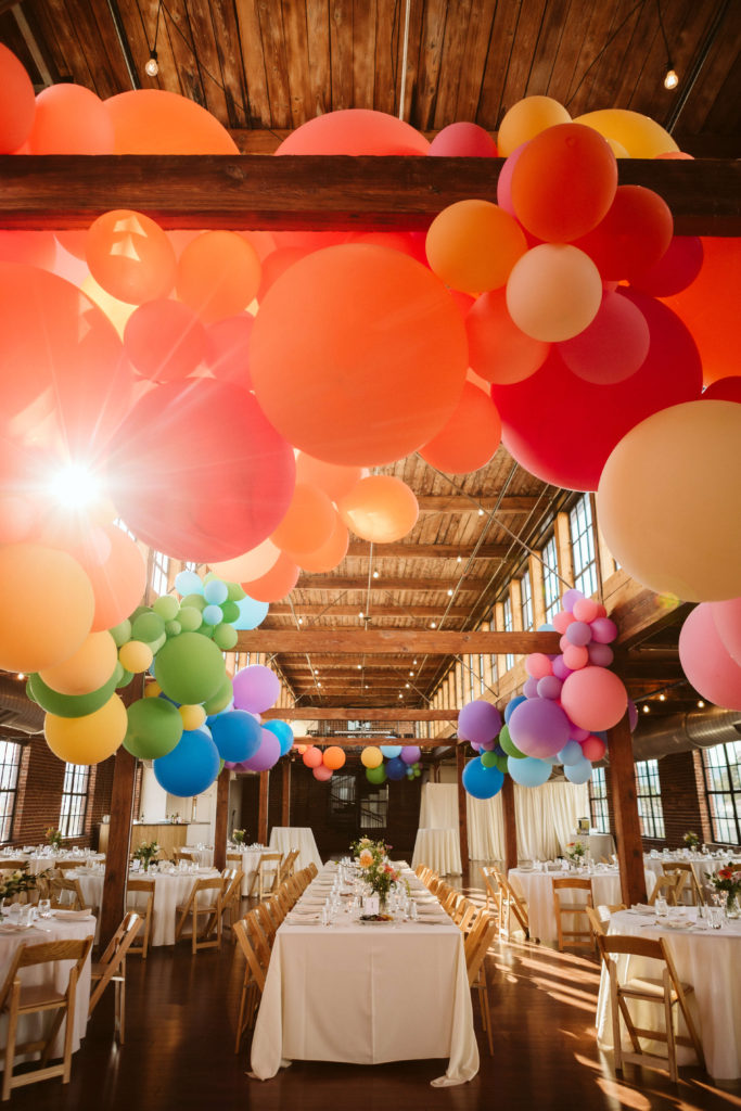 Colorful wedding decorations for a modern industrial wedding at the Turnbull Building in Chattanooga. Photo by OkCrowe Photography.